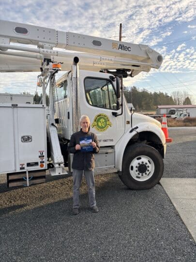 Brian Silverstein, Orcas Power & Light Cooperative board member and former Bonneville Power Administration senior vice president of transmission, holds a copy of a newly signed BPA contract.