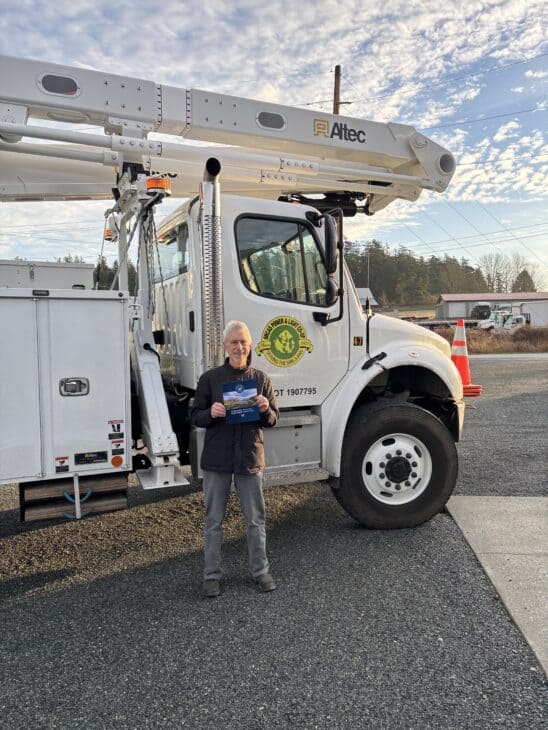Brian Silverstein, Orcas Power & Light Cooperative board member and former Bonneville Power Administration senior vice president of transmission, holds a copy of a newly signed BPA contract.