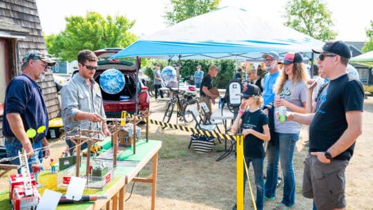 OPALCO crew doing a safety board demonstration for members at the EV Jamboree on Lopez Island in 2023.