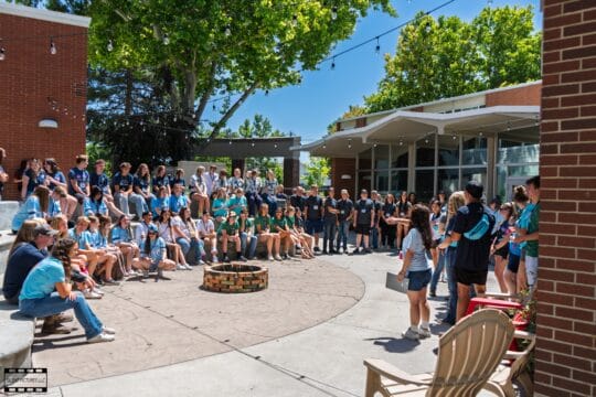 Students sitting outside listening to activity instructions